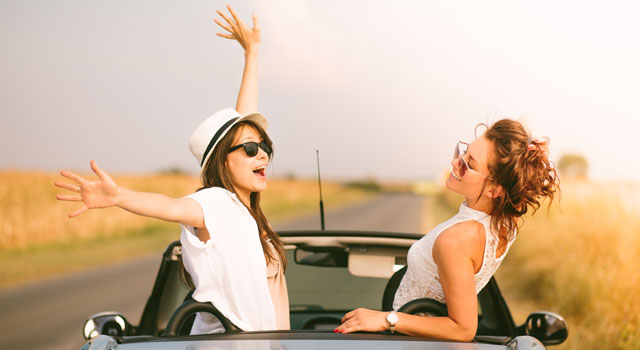 two women having fun in a car